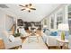 Bright open-concept living room showcases hardwood floors, a ceiling fan, and flows into a modern kitchen at 1557 Tice Hurst Ln, Apex, NC 27502
