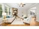Bright living room features a stone fireplace, hardwood floors, and many windows for plenty of natural light at 1557 Tice Hurst Ln, Apex, NC 27502
