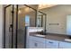Contemporary bathroom featuring a glass-enclosed shower, double vanity, sleek fixtures, and neutral tones at 1565 Wendell Valley Blvd, Wendell, NC 27591