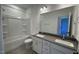 Modern bathroom with double sinks, gray countertops, and a shower-tub combination, and tiled floor at 1565 Wendell Valley Blvd, Wendell, NC 27591