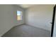 This bedroom has neutral colored walls, carpet, and a good sized window at 1565 Wendell Valley Blvd, Wendell, NC 27591