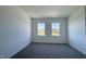 Serene bedroom featuring neutral carpet, large windows, and ample natural light at 1565 Wendell Valley Blvd, Wendell, NC 27591