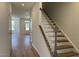 Bright entryway with wood-look flooring, a staircase with white railings, and a view into the spacious living areas at 1565 Wendell Valley Blvd, Wendell, NC 27591