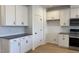 Well-lit kitchen featuring white cabinets, granite countertops, stainless steel appliances, and stylish backsplash at 1565 Wendell Valley Blvd, Wendell, NC 27591