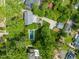 An aerial view of the home featuring mature landscaping, a two car garage and swimming pool at 1603 Hermitage Ct, Durham, NC 27707