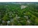 An aerial view of a lush neighborhood with mature trees and the skyline in the distance at 1603 Hermitage Ct, Durham, NC 27707