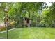 A backyard play area featuring a treehouse with a hammock at 1603 Hermitage Ct, Durham, NC 27707