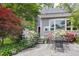 Backyard featuring a patio, outdoor seating, and vibrant flowerbeds at 1603 Hermitage Ct, Durham, NC 27707