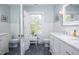 Updated bathroom with white subway tiles, mosaic floors, and a window with natural light at 1603 Hermitage Ct, Durham, NC 27707