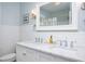 Bright bathroom featuring double sinks, white marble countertops, and modern fixtures at 1603 Hermitage Ct, Durham, NC 27707