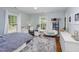 Bright bedroom featuring large windows, hardwood floors, and a comfortable sitting area at 1603 Hermitage Ct, Durham, NC 27707