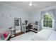 Cozy bedroom with a plush rug, desk, and a large window providing ample natural light at 1603 Hermitage Ct, Durham, NC 27707