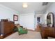 Cozy bedroom featuring hardwood floors, a large closet, and a green velvet chaise lounge at 1603 Hermitage Ct, Durham, NC 27707