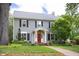 Charming two-story home with gray siding, black shutters, a bright red front door, and a well-manicured front yard at 1603 Hermitage Ct, Durham, NC 27707