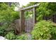 Wooden gate with an arbor and flowering plants at 1603 Hermitage Ct, Durham, NC 27707
