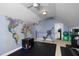 Home gym featuring various exercise equipment, a ceiling fan, and a colorful world map at 1603 Hermitage Ct, Durham, NC 27707