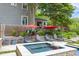Outdoor seating area with a hot tub next to the in-ground swimming pool at 1603 Hermitage Ct, Durham, NC 27707