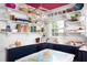 Eat-in kitchen features a custom banquette, open shelving, and statement light fixture at 1603 Hermitage Ct, Durham, NC 27707