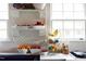 Open shelving and fruit display adds to this kitchens charm at 1603 Hermitage Ct, Durham, NC 27707