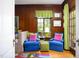 Inviting living room with wood-paneled walls, comfortable seating, and a bright, colorful rug, creating a cozy space at 1603 Hermitage Ct, Durham, NC 27707