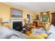 Spacious living room with a fireplace, plush sofas, and stylish decor, perfect for relaxation and entertaining guests at 1603 Hermitage Ct, Durham, NC 27707
