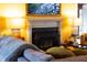 Cozy living room featuring a fireplace, comfortable seating, and warm lighting, creating an inviting atmosphere at 1603 Hermitage Ct, Durham, NC 27707