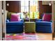 This room features a pair of chairs, a colorful rug, and lots of bright light at 1603 Hermitage Ct, Durham, NC 27707