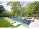 Backyard swimming pool and hot tub with patio space surrounded by a green lawn at 1603 Hermitage Ct, Durham, NC 27707
