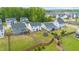 Aerial view of backyard and neighborhood; mature trees and fenced in yard at 176 Belleforte Park Cir, Garner, NC 27529