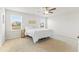 Serene bedroom with neutral carpet, ceiling fan, and two large windows offering plenty of natural light at 176 Belleforte Park Cir, Garner, NC 27529