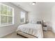Comfortable bedroom with a queen-sized bed, soft carpet, and ample natural light at 176 Belleforte Park Cir, Garner, NC 27529