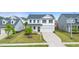 Beautiful two-story home with a well-manicured lawn and a long driveway leading to the garage at 176 Belleforte Park Cir, Garner, NC 27529
