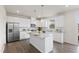 Modern kitchen with white cabinetry, stainless steel appliances, and a granite-topped island at 176 Belleforte Park Cir, Garner, NC 27529
