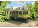 Backyard exterior view features a screened in porch, wooden deck, lush green landscaping and partial shade at 19002 Stone Brk, Chapel Hill, NC 27517