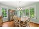 Inviting dining room with wood floors, a chandelier, and multiple windows for natural light at 19002 Stone Brk, Chapel Hill, NC 27517