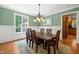 Formal dining room showcases wainscoting, a modern chandelier, and neutral paint tones at 19002 Stone Brk, Chapel Hill, NC 27517