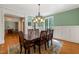 Elegant dining room with decorative trim and chandelier overlooking backyard at 19002 Stone Brk, Chapel Hill, NC 27517