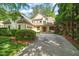 Traditional home with neutral siding, a prominent front porch, and a wide driveway and well manicured greenery at 19002 Stone Brk, Chapel Hill, NC 27517