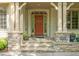 Charming front entrance featuring a rustic stone base, an arched doorway, and sidelight windows at 19002 Stone Brk, Chapel Hill, NC 27517
