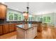 Gourmet kitchen features granite countertops, hardwood floors, a kitchen island, and ample natural light at 19002 Stone Brk, Chapel Hill, NC 27517