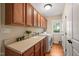 Laundry room features wood cabinets, a sink, washer and dryer, a large window, and wood flooring at 19002 Stone Brk, Chapel Hill, NC 27517