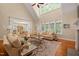 Bright living room boasts vaulted ceilings, large windows, hardwood floors, and neutral paint tones at 19002 Stone Brk, Chapel Hill, NC 27517