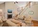 Inviting living room with a cozy fireplace, staircase, and comfortable seating at 19002 Stone Brk, Chapel Hill, NC 27517