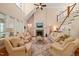 Bright living room boasting soaring ceilings, a fireplace, and a staircase to the second floor at 19002 Stone Brk, Chapel Hill, NC 27517