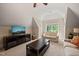 Living room with a ceiling fan, plush carpeting, a television, two windows, and light colored walls at 19002 Stone Brk, Chapel Hill, NC 27517