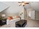 Living room features a light colored sofa, ceiling fan, two windows, and neutral walls with plush carpeting at 19002 Stone Brk, Chapel Hill, NC 27517