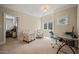 Office space with desk, two floral chairs, neutral carpet, and lots of natural light from two large windows at 19002 Stone Brk, Chapel Hill, NC 27517