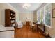 Sunlit home office featuring hardwood floors, a classic desk, and comfortable seating at 19002 Stone Brk, Chapel Hill, NC 27517