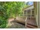 A cozy screened patio extends from the home and connects to a wooden deck surrounded by lush foliage at 19002 Stone Brk, Chapel Hill, NC 27517