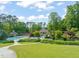 Aerial view of a community pool surrounded by lush landscaping, walking paths, and pergolas at 19002 Stone Brk, Chapel Hill, NC 27517